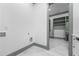 Laundry hookups with white cabinets visible from an open doorway to a closet area at 632 Hunters Cove Ln., Loganville, GA 30052