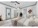 Main bedroom has sitting area, white comforter, door to outdoor space, and ensuite bath at 632 Hunters Cove Ln., Loganville, GA 30052