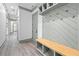 Mudroom featuring a built-in bench with storage, wall hooks, and wood-look flooring at 632 Hunters Cove Ln., Loganville, GA 30052
