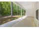 Covered patio featuring bright lighting and backyard view of lush green trees at 632 Hunters Cove Ln., Loganville, GA 30052