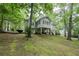 Charming home featuring a spacious deck and lush green landscaping, perfect for outdoor enjoyment at 7533 Mason Falls Dr, Winston, GA 30187