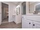 Bathroom featuring light-colored wood look flooring, and double sink vanity with white cabinets at 7533 Mason Falls Dr, Winston, GA 30187