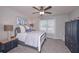 Bedroom with a ceiling fan, complemented by a cute blue nightstand and decorative donkey artwork at 7533 Mason Falls Dr, Winston, GA 30187