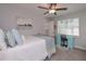 Neutral bedroom featuring a ceiling fan, a bright desk, and natural light at 7533 Mason Falls Dr, Winston, GA 30187