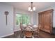 Charming dining area with a vintage cabinet and views of the backyard at 7533 Mason Falls Dr, Winston, GA 30187
