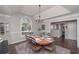 Spacious dining room with a vaulted ceiling, large window, and a traditional chandelier at 7533 Mason Falls Dr, Winston, GA 30187
