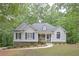 Charming home featuring blue shutters, a manicured lawn, and a welcoming front porch at 7533 Mason Falls Dr, Winston, GA 30187