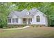 Quaint single-story home with blue shutters, tidy landscaping, and a peaceful wooded setting at 7533 Mason Falls Dr, Winston, GA 30187