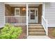 Inviting front porch with cedar shingles and white trim detail at 7533 Mason Falls Dr, Winston, GA 30187