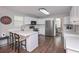 Modern kitchen with white cabinets, stainless steel appliances, and island seating at 7533 Mason Falls Dr, Winston, GA 30187