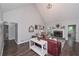 Bright living room featuring high ceilings, a fireplace, and a cozy seating area at 7533 Mason Falls Dr, Winston, GA 30187