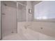 Bright main bath featuring separate soaking tub and tiled walk-in shower at 7533 Mason Falls Dr, Winston, GA 30187
