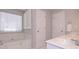 Light-filled main bathroom featuring a soaking tub, and white cabinets at 7533 Mason Falls Dr, Winston, GA 30187