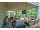 Relaxing covered patio with comfortable seating, a swing, and a TV, ideal for outdoor entertaining at 7533 Mason Falls Dr, Winston, GA 30187