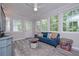 Cozy sunroom filled with natural light from the surrounding windows at 7533 Mason Falls Dr, Winston, GA 30187