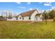 Spacious backyard with green grass and the rear of the home at 105 Hunters, Mcdonough, GA 30253