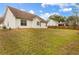 Spacious backyard with a well-maintained lawn, white siding house, and a wooden fence at 105 Hunters, Mcdonough, GA 30253