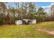 View of backyard with shed, mature trees, and green grass at 105 Hunters, Mcdonough, GA 30253