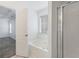 Bathroom with soaking tub, shower, and large window at 105 Hunters, Mcdonough, GA 30253
