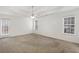 Spacious bedroom with neutral carpet, ceiling fan, and plenty of natural light at 105 Hunters, Mcdonough, GA 30253