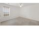 This bedroom features carpet, a ceiling fan, and a window at 105 Hunters, Mcdonough, GA 30253