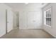 Clean bedroom features carpet, a window, and a double door closet at 105 Hunters, Mcdonough, GA 30253