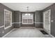 Dining room with tile flooring, wainscotting, and a modern chandelier at 105 Hunters, Mcdonough, GA 30253
