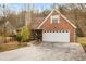 Charming brick home with a two-car garage and a well-maintained front yard and driveway at 105 Hunters, Mcdonough, GA 30253