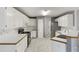 Well-lit kitchen with white cabinets, modern appliances, and tile floors at 105 Hunters, Mcdonough, GA 30253