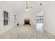 Spacious living area featuring high ceilings, a brick fireplace, and tile flooring at 105 Hunters, Mcdonough, GA 30253