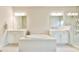 Bright and airy bathroom with a soaking tub, and sinks, and a glass enclosed shower at 1122 Provence Ln, Decatur, GA 30033