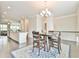 Dining room with hardwood floors, neutral walls, and a view of a staircase and kitchen at 1122 Provence Ln, Decatur, GA 30033