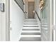 A view of the entryway with white and dark wood stairs at 1122 Provence Ln, Decatur, GA 30033