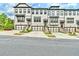 A stunning exterior view of modern townhomes, each featuring a private garage and inviting entryways at 1122 Provence Ln, Decatur, GA 30033