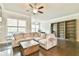 Spacious living room with a cozy sectional sofa, a ceiling fan, and custom built-in shelving at 1122 Provence Ln, Decatur, GA 30033