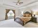 Relaxing main bedroom suite features trey ceilings, large bed, bedside tables, and large windows at 1122 Provence Ln, Decatur, GA 30033