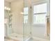 Bathroom features a modern walk-in shower with glass door, tile surround and rain shower head at 1122 Provence Ln, Decatur, GA 30033