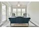 Comfortable sitting area with neutral paint, a decorative rug, and natural light from three windows at 1122 Provence Ln, Decatur, GA 30033