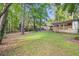 A spacious backyard with lush green grass and mature trees surrounding the property at 1461 Alverado Way, Decatur, GA 30032