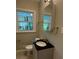 Cozy bathroom with dark countertop, neutral tones and a window bringing in light at 1461 Alverado Way, Decatur, GA 30032