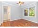Bedroom featuring wood floors, a ceiling fan, and natural light from two windows at 1461 Alverado Way, Decatur, GA 30032