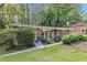 Well-kept brick home with mature landscaping, including green bushes, on a sunny lot at 1461 Alverado Way, Decatur, GA 30032