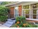 Covered front porch with black railing and a garden featuring colorful flowers at 1461 Alverado Way, Decatur, GA 30032