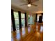 Bright living room with hardwood floors, ceiling fan, and abundant natural light through large windows at 1461 Alverado Way, Decatur, GA 30032