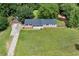 An aerial view of a charming single-story home with a spacious lawn and mature trees at 1810 King Mill Rd, Mcdonough, GA 30252