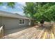 Large wooden deck is surrounded by mature trees, providing a shaded, peaceful outdoor space at 1810 King Mill Rd, Mcdonough, GA 30252