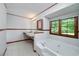 Bright bathroom with a large window, soaking tub, and unique floating sink with and faucets at 1810 King Mill Rd, Mcdonough, GA 30252