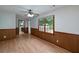 Dining area with wood-look floors, paneled walls, ceiling fan, and large window at 1810 King Mill Rd, Mcdonough, GA 30252