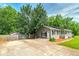 Features a detached garage and a long driveway with ample parking space at 1810 King Mill Rd, Mcdonough, GA 30252