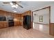 Spacious kitchen with wooden cabinets, black appliances, and light wood-look flooring at 1810 King Mill Rd, Mcdonough, GA 30252